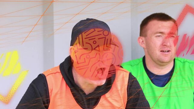 Sports subs on bench reacting to off-field action, leaning, pointing while overlays crossing faces