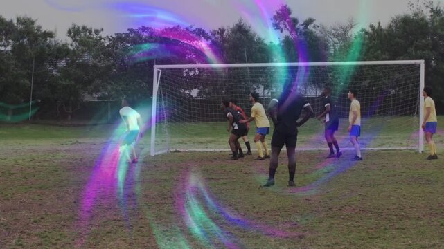 Male attackers jostling incoming cross at soccer goal to score, color overlay masking then clearing