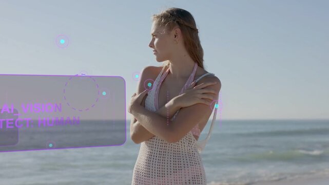 Woman standing at shoreline, AI panels detecting subject and highlighting body, camera tightening