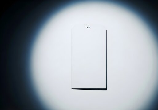 Blank white rectangular hang tag with rounded top corners under intense spotlight, product branding, sales retail display