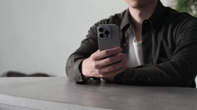 スマホを見て悩む男性