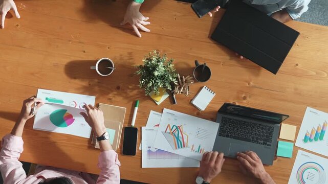 Top view of business team attend meeting while prepare working and analyzing data. Group of diverse people planning creative and working on start up project while team joining conference. Convocation.