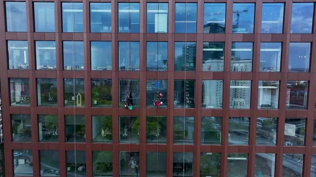Aerial Poland window washers high rise building 2. Historical capital of Greater Poland. Academic, scientific, and cultural center. Metropolitan area with modern high rise business and apartments.