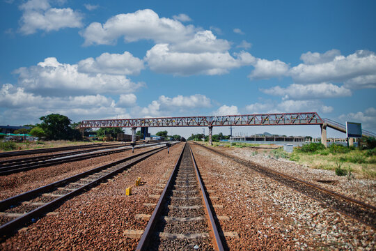 Railway Tracks Receding Towards a Pedestrian Overpass pedestrian Bridge