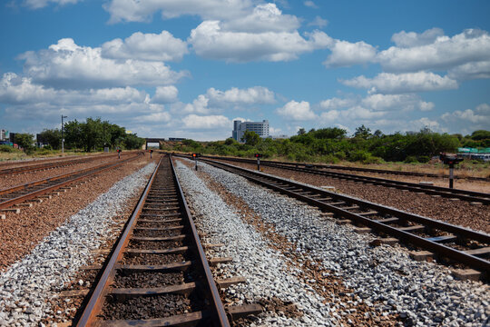 wide-angle perspective  Multiple Railway Tracks Receding Toward a City Horizon