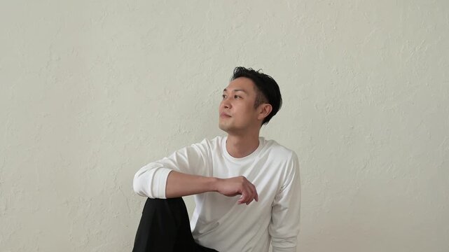 リビングで座ってリラックスする日本人男性