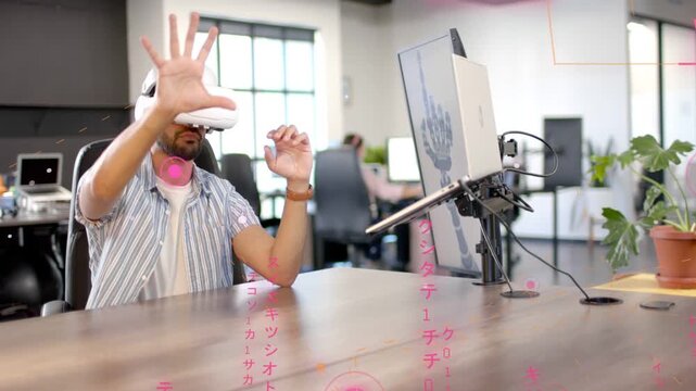 Man with white VR headset raising hands activating pink holo UI, testing tech interface on monitor