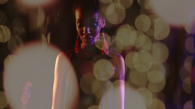 Hands striking keys initiating music, woman performing expressing emotion, bokeh accenting gestures