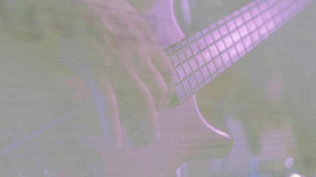 Bassist fretting and plucking fretboard as drummer keeping beat camera moving closer for live music