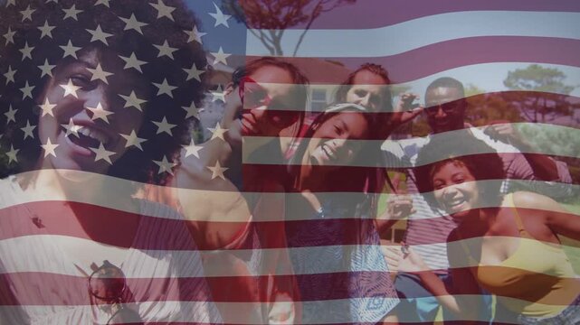 Six adults posing in park, left holding phone starting selfie, flag overlay rippling for marketing