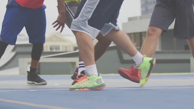 Neon-shoed dribbler doing low crossover after defender lunging, evading tight basketball cluster