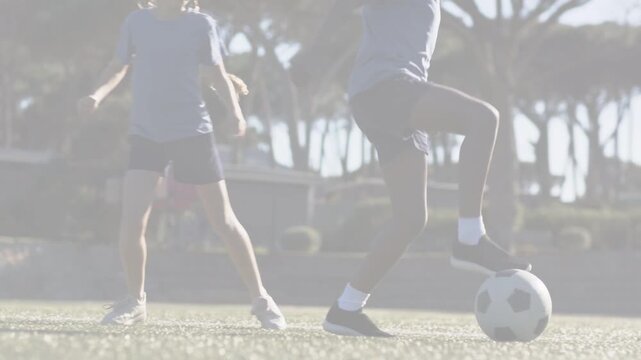 Youth male pressing opponent, aiming to gain ball after slide, then dribbling forward in sport