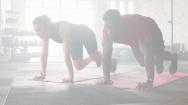 On timer start, workout pair doing plank knee tucks on mats, animated rep counter tracking pace