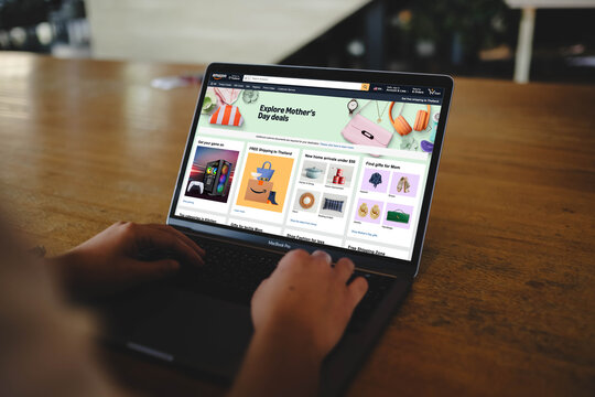 Bangkok, Thailand. April 20, 2026; A person is using a MacBook Pro laptop to browse the Amazon website featuring Mother's Day promotion deals.