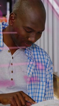 mature man glancing at market deli, leaning, pointing and selecting meal with pink script on glass