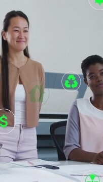 Vertical video: Standing rep reaching to shake offscreen hand sealing eco deal while icons floating