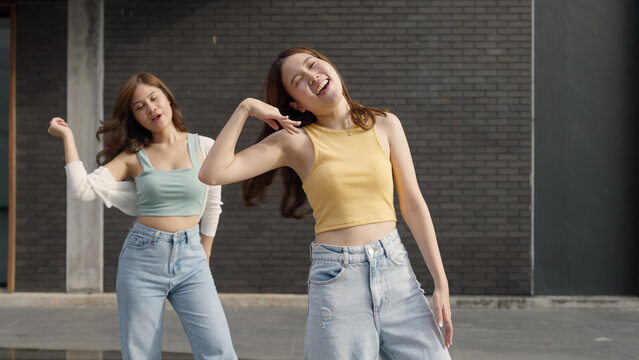 Gen z vlogger influencer asia teen girl trending relax smile moving dance at city park street record on IG reel tiktok instagram app young youtuber play fun joy selfie post show share viral vlog video