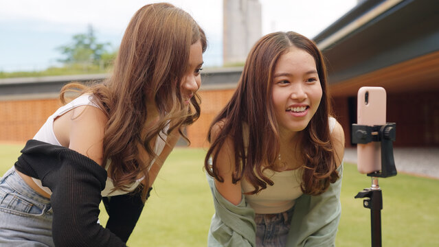 Gen z vlogger influencer asia teen girl trending relax smile moving dance at city park street record on IG reel tiktok instagram app young youtuber play fun joy selfie post show share viral vlog video