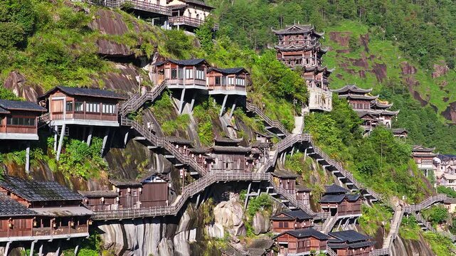 Ancient village and traditional wooden buildings built on the cliffs at the famous Wangxiang Valley Scenic Area in Jiangxi, China