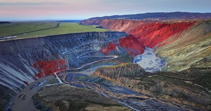 Aerial view of the spectacular Anjihai Grand Canyon with winding river and mountains during sunset in Xinjiang, China