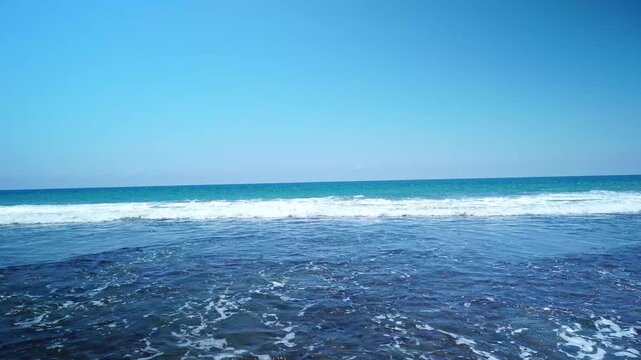 Powerful Ocean Waves Breaking on Open Blue Sea with Clear Sky and Clean Horizon - 4K Footage