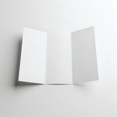 Two sheets of paper folded at an angle against a plain background