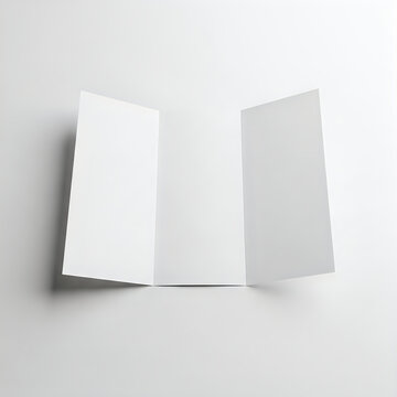 Two sheets of paper folded at an angle against a plain background