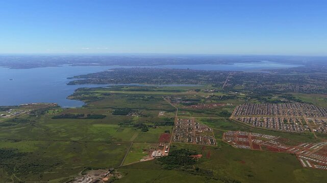 Urban expansion near Posadas Misiones Argentina with plotted residential areas and road grid across Parana River floodplain within subtropical Mesopotamia region near Encarnacion Paraguay, aerial high