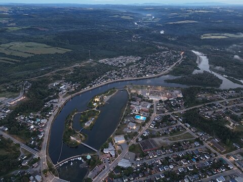 Aerial view of Matane city at dusk with river, fog, low clouds and city lights along St Lawrence River, Quebec, Canada. g.