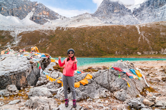 Young female hiker enjoys achievement with the beautiful landscape views, freedom, exploration and outdoor lifestyle