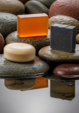 Spa soaps on wet pebbles, natural hygiene, bath products, smooth stones, clean wash, aromatic cleanse.