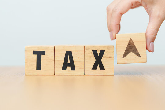 hand change wooden block with TAX text to UP and Down arrow icon. decrease and Increase, Taxpayer, Taxable Income, Tax Filing, Deduction, Withholding Tax, WHT, VAT, Computation and Exemption concept