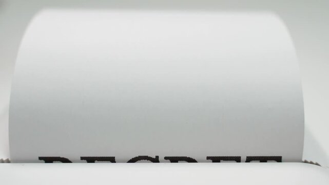Word regret printed on white paper coming out of printer or typewriter