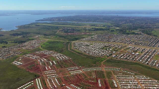 Aerial lateral flight revealing Itaembe Guazu in Posadas, Argentina with large scale housing and urban expansion.