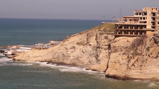 Beirut coastline featuring limestone cliffs and the Mediterranean horizon. Scenic landscape of the rocky shore near the Raouche district in Lebanon