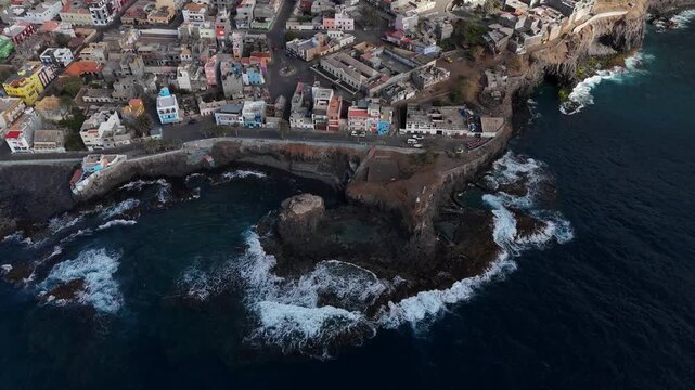 aerial perspective of the coastal town Ponta do Sol in Santo Antao, Cabo Verde. Colorful buildings perched on volcanic cliffs overlooking the deep blue Atlantic ocean
