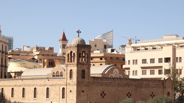Pan view of downtown Beirut featuring the Saint George Maronite Cathedral bell tower and historic stone buildings. A visual testament to Lebanon's religious diversity and its beautifully restored urba