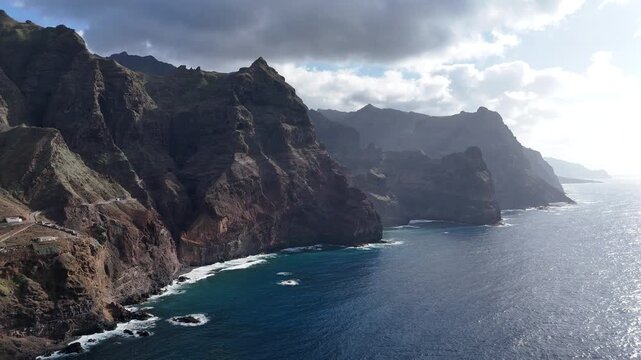 Cinematic drone flight along the massive volcanic cliffs of Ponta do Sol in Santo Antao. Aerial view of the rugged coastline meeting the deep blue Atlantic Ocean in Cape Verde islands