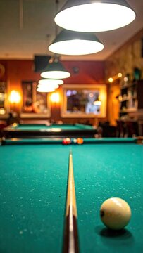Billiard cue aimed at cue ball on green felt pool table under bright lights in vintage bar for recreation and leisure
