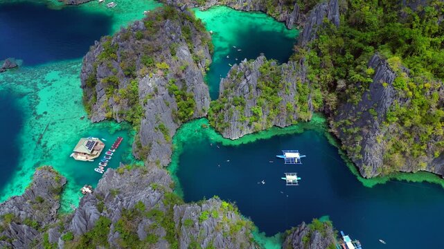 time lapse Philippines Palawan region seascape with clear turquoise water, limestone cliffs, green vegetation, and traditional boats. Great aerial view overflight flyover panorama drone