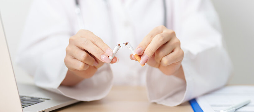doctor hand making stop sign to refuse and breaking cigarette, quitting smoking for healthy lungs, prevent Lung Cancer and Emphysema, World No Tobacco Day concept