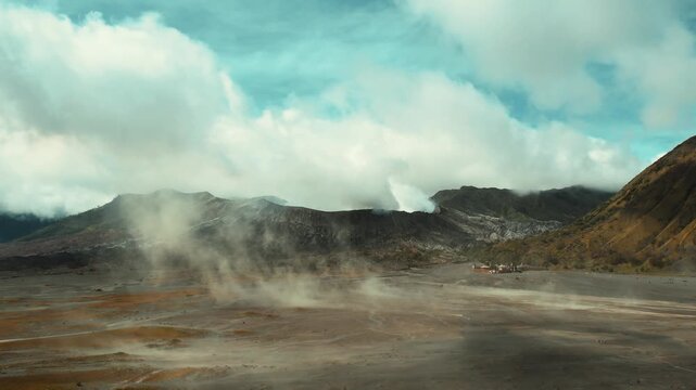 Drone overview of massive white plume rising from Mount Bromo crater, East Java, Indonesia