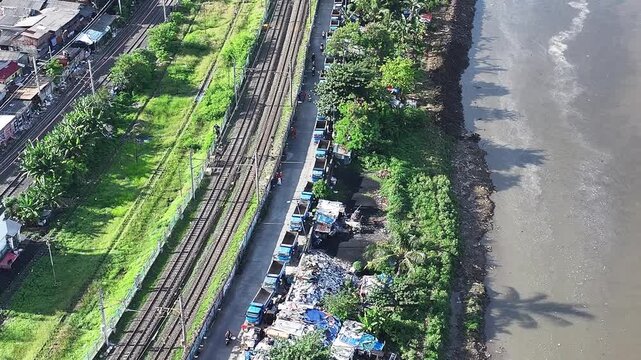 Aerial view The blue and yellow excavator is working to dig and clean the river from mud and rubbish, removing it to the edge of the river middle city 