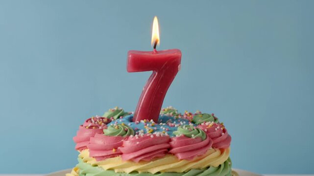 Birthday Cake with Lit Red Number Seven Candle for 7th Anniversary
