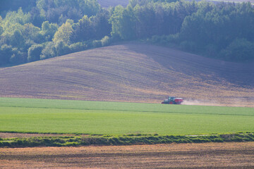 Obraz premium Tractor working on the field in Moravia