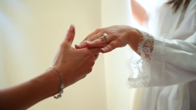 Bride showing her hand with engagement ring, close up shot. Preparation of the bride, Morning of the bride.