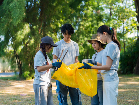 Group of Asian people helped to clean up litter in public place