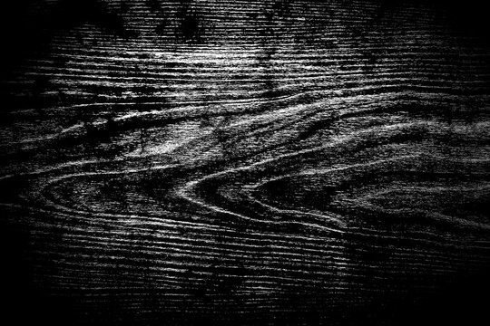 Dark black wooden surface texture with natural grain pattern background.