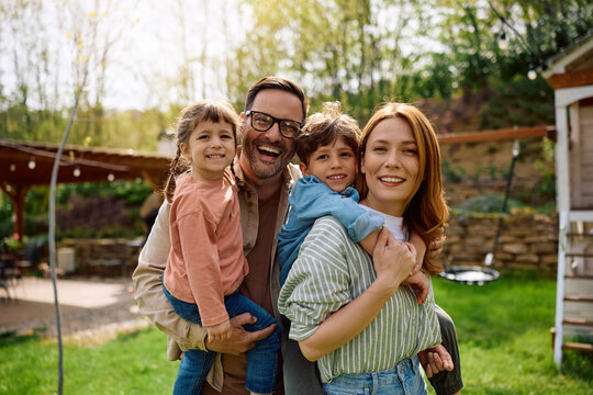 Portrait of happy family in springtime looking at camera.
