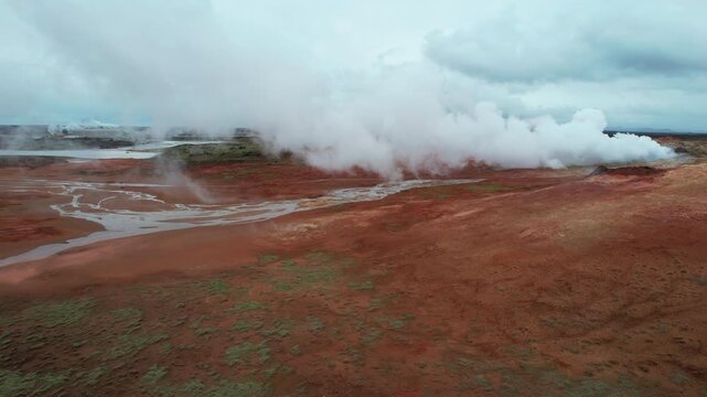 Stunning aerial perspective of the Gunnuhver geothermal area in Iceland, showcasing rising steam from fumaroles and colorful mineral deposits